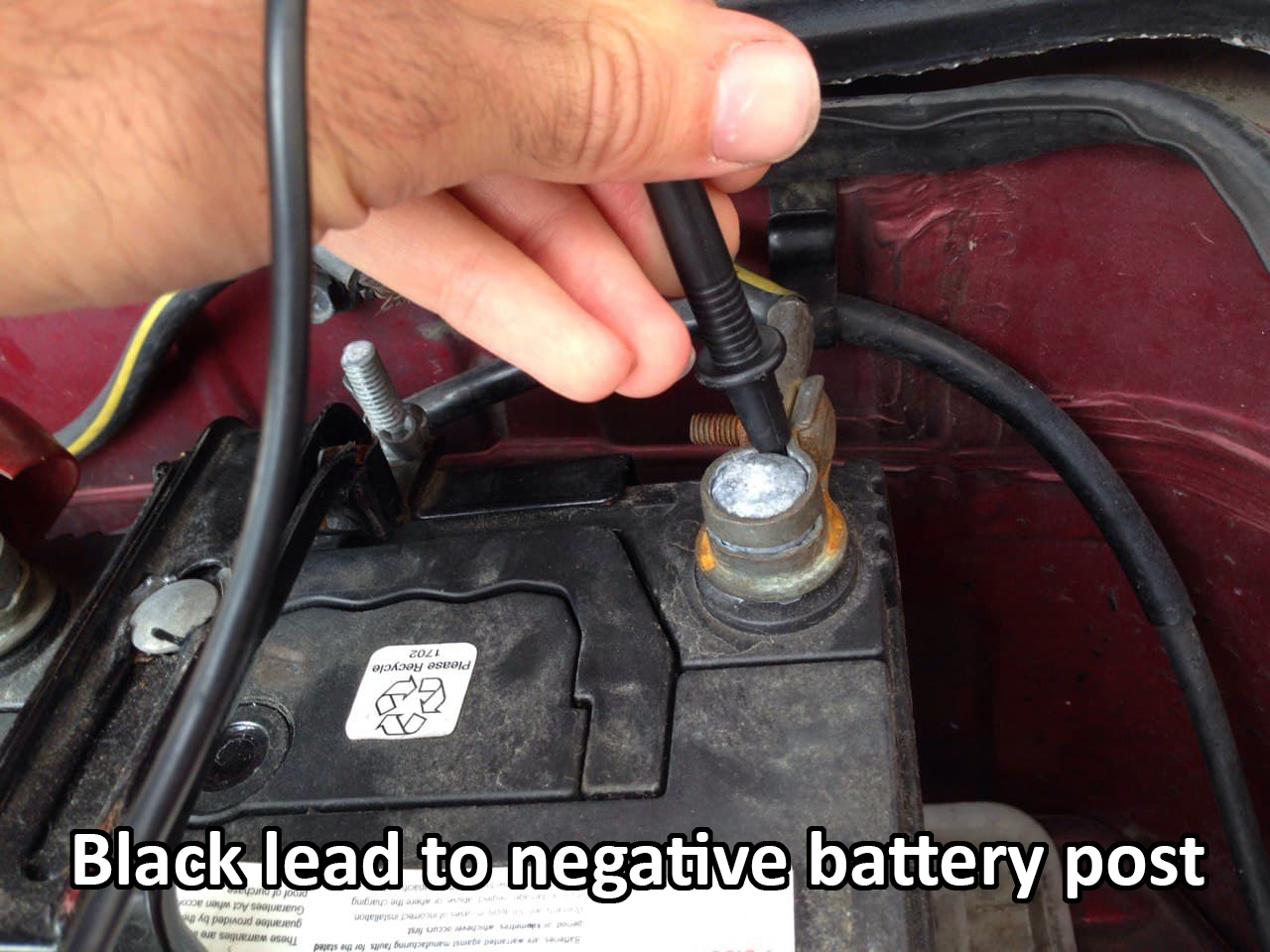 Placing negative lead on the negative battery post